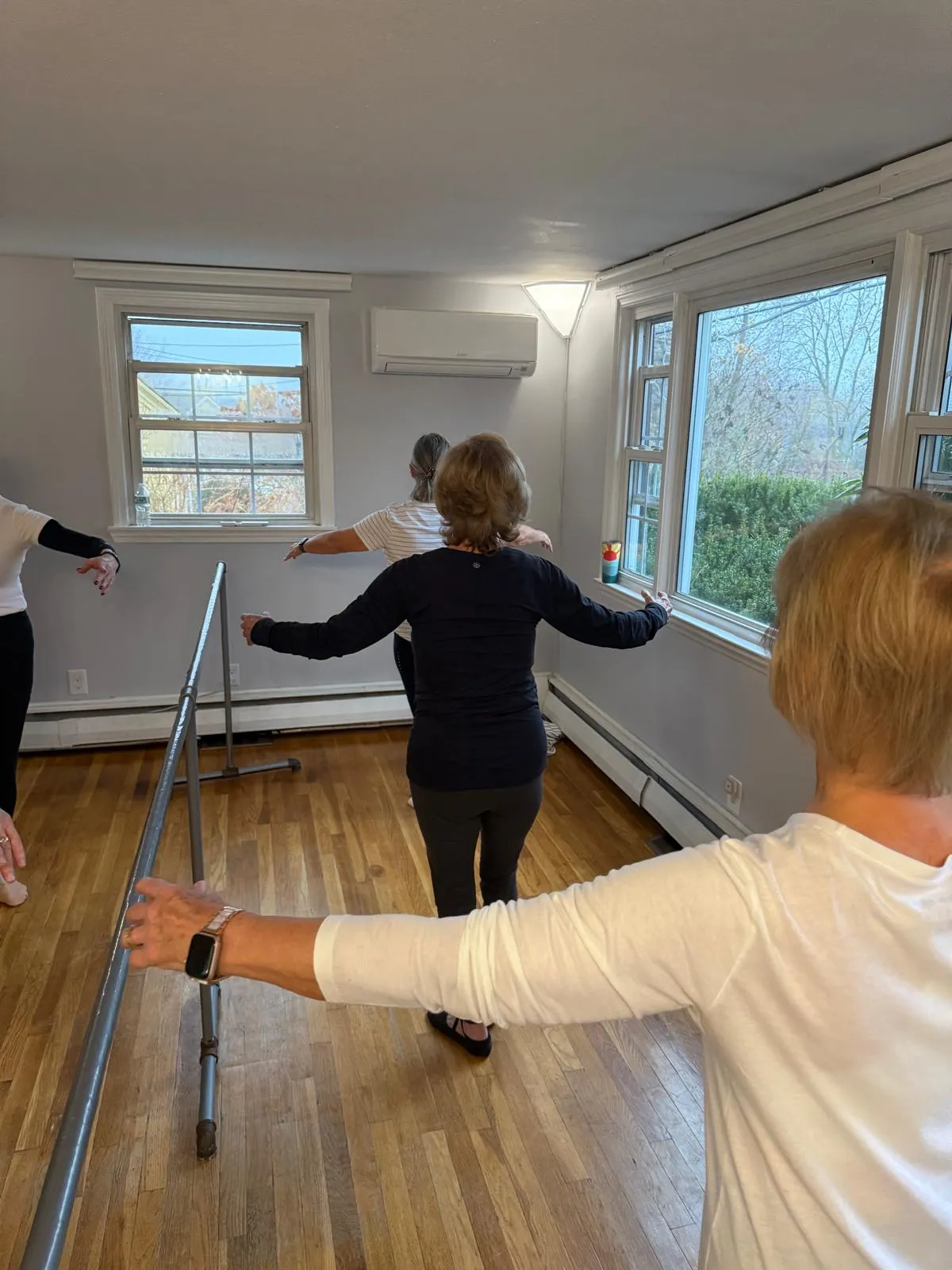 Adult ballet students training at the barre in the VW Dance studio in South Weymouth