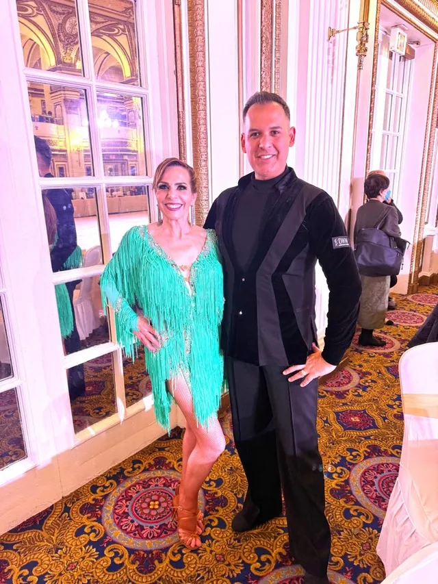 Couple dressed in Latin dance costume at a VW Dance social event