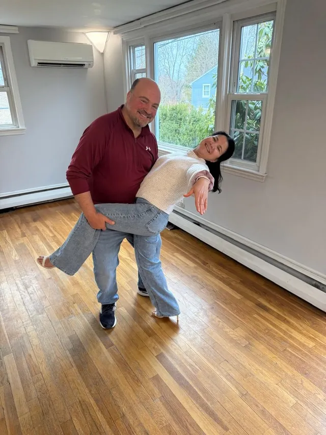 Couple sharing a playful social dance moment on the VW Dance studio floor